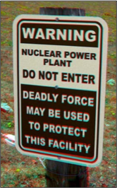 Warning sign outside a nuclear power plant stating that deadly force may be used to protect the facility from unauthorized entry.
